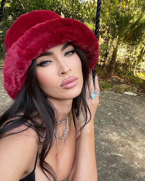 Megan Fox red French tip nails and furry hat selfie