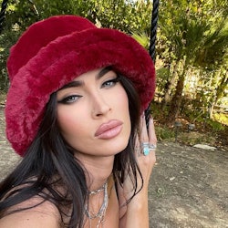 Megan Fox red French tip nails and furry hat selfie