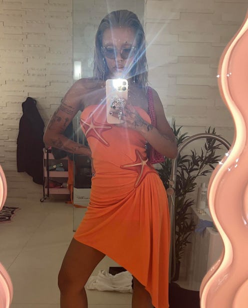 Doja Cat showed off a 3D nail design that included rhinestones, cross nail art, and heart-shaped pea...