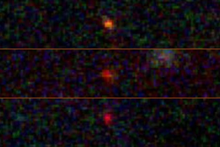 Three hazy dots are lined up one above another, showcasing their similarities. The image is pixelate...