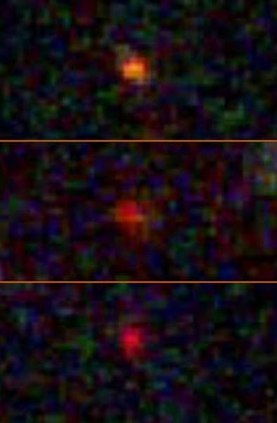 Three hazy dots are lined up one above another, showcasing their similarities. The image is pixelate...