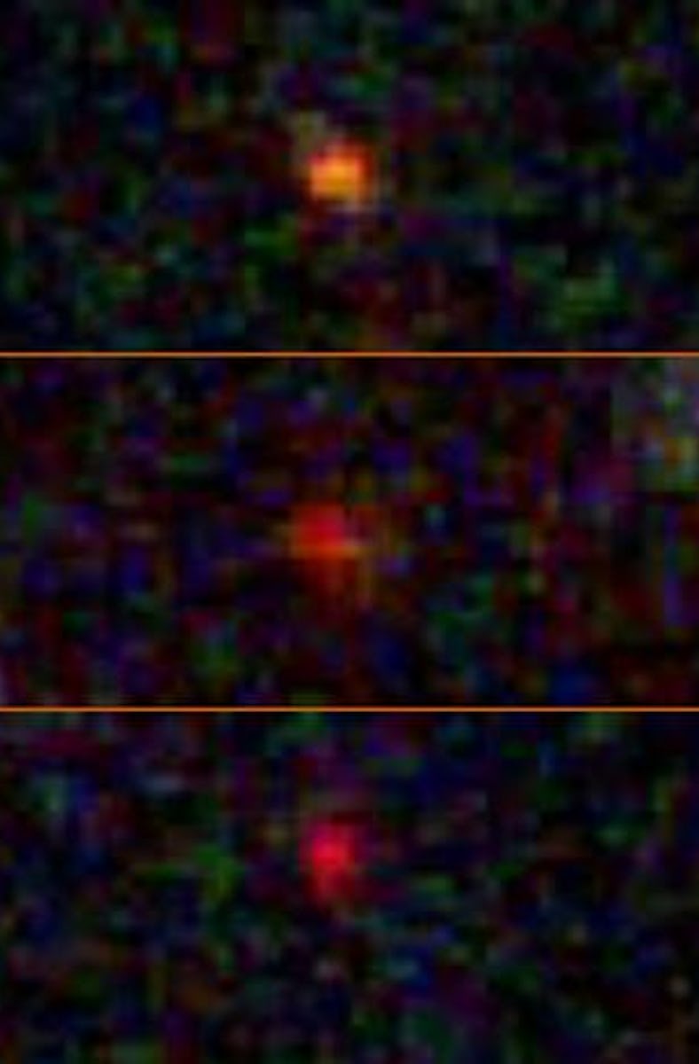 Three hazy dots are lined up one above another, showcasing their similarities. The image is pixelate...