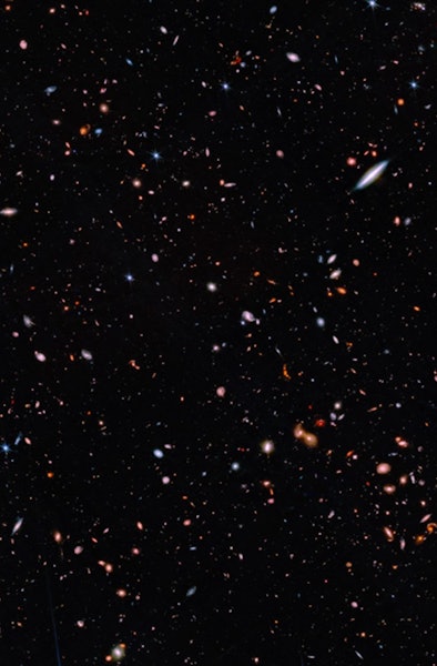 Galaxies of different sizes sparkle across this image. Some are much larger, because they are closer...