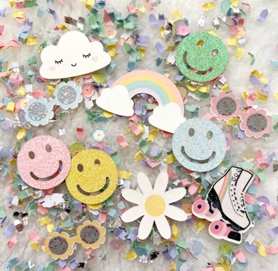 Confetti with daisies and smiley faces for a 70s birthday party