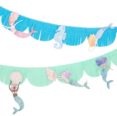 A blue fringe mermaid birthday party garland with mermaids throughout