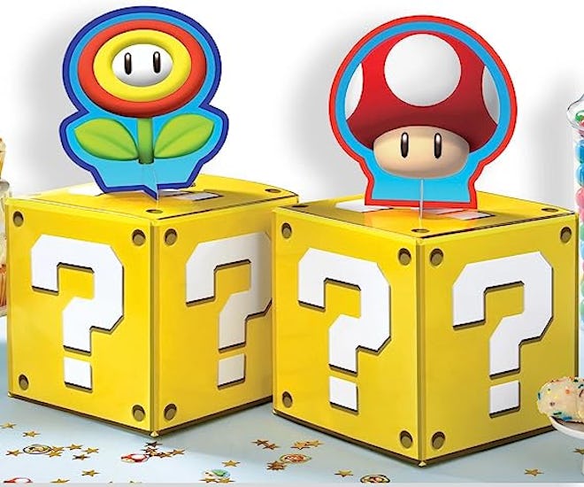 Mario birthday party decorations, yellow coin block centerpieces with Toad on top