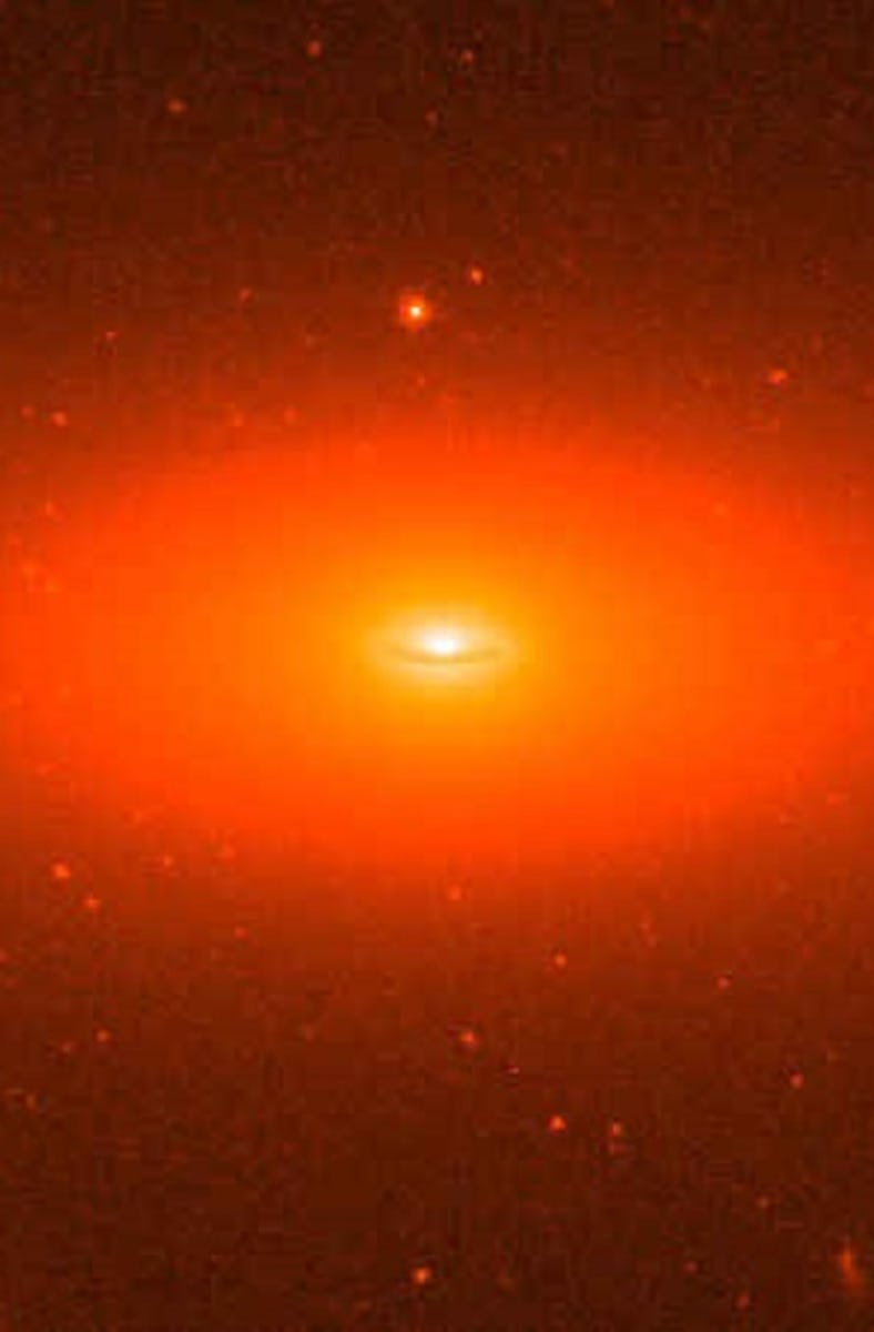 An oval-shaped galaxy, glowing in shades of red like a baleful giant eye