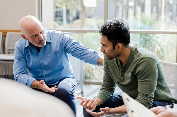 Older man and younger man having heartfelt conversation