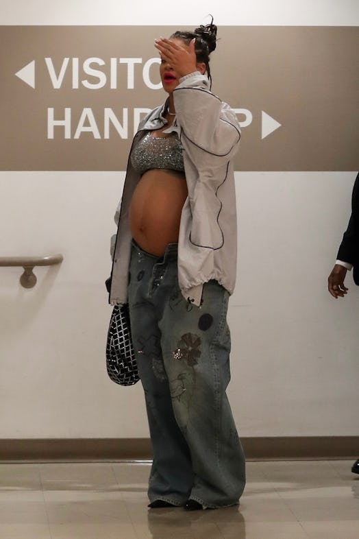 Rihanna wears a sequin crop top and low-rise jeans in Los Angeles, California.