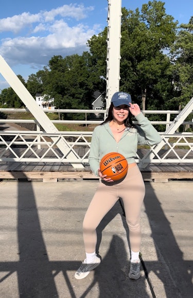 The writer poses with a basketball on the One Tree Hill. bridge in North Carolina.