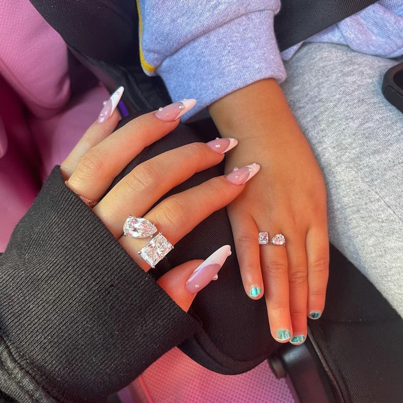 Kylie Jenner pearl french tip nails with Stormi and diamond rings from travis Scott