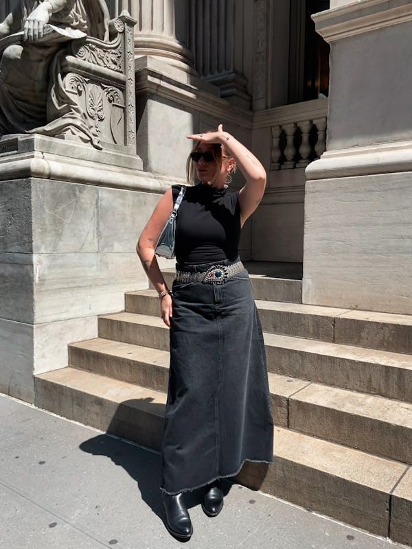 kelsey stiegman bustle's senior fashion editor wears reformation's lindy knit top with a black denim...