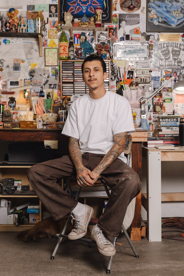 Mario Ayala sitting in his studio in Los Angeles