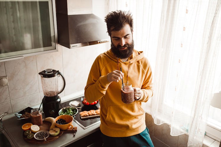 A man drinking a smoothie to lower his blood pressure.