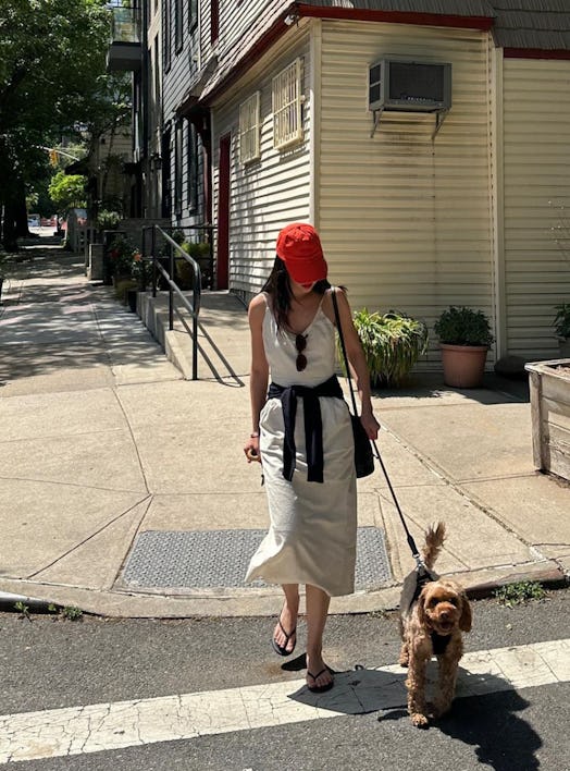 mimixn asian girl walks dog under sun with red hat
