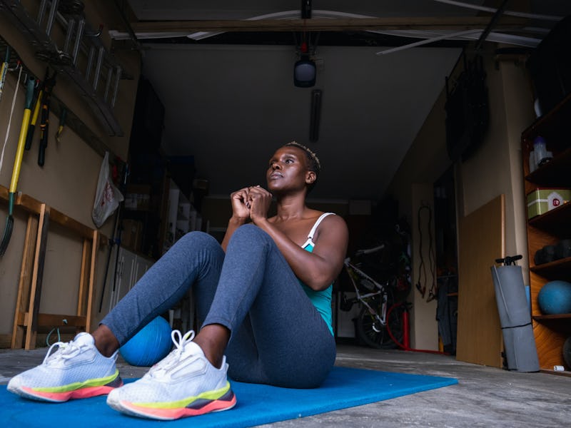 A woman doing sit-ups on the weekend.