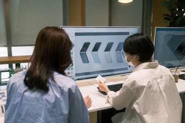 Two Samsung designers looking at a color sample for the Galaxy Z Flip 5.