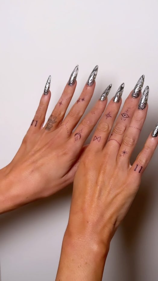 Megan Fox silver chrome nails and finger tattoos