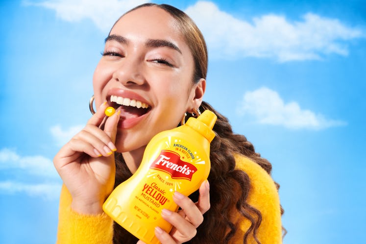 A woman tries the French's Mustard Skittles for National Mustard Day.