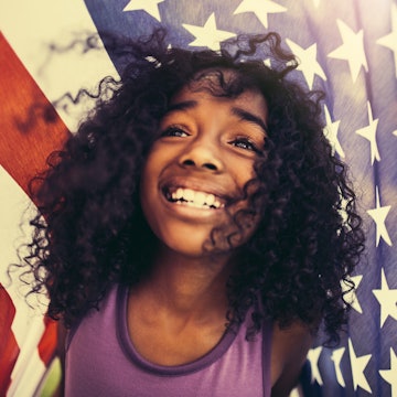 A girl holds an American flag