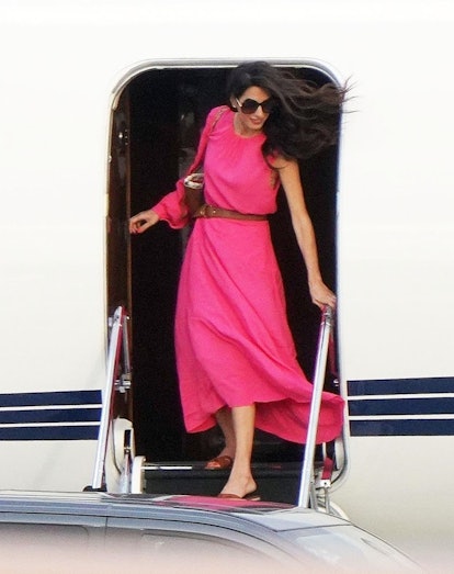 Amal Clooney in a hot pink summer dress in 2022.