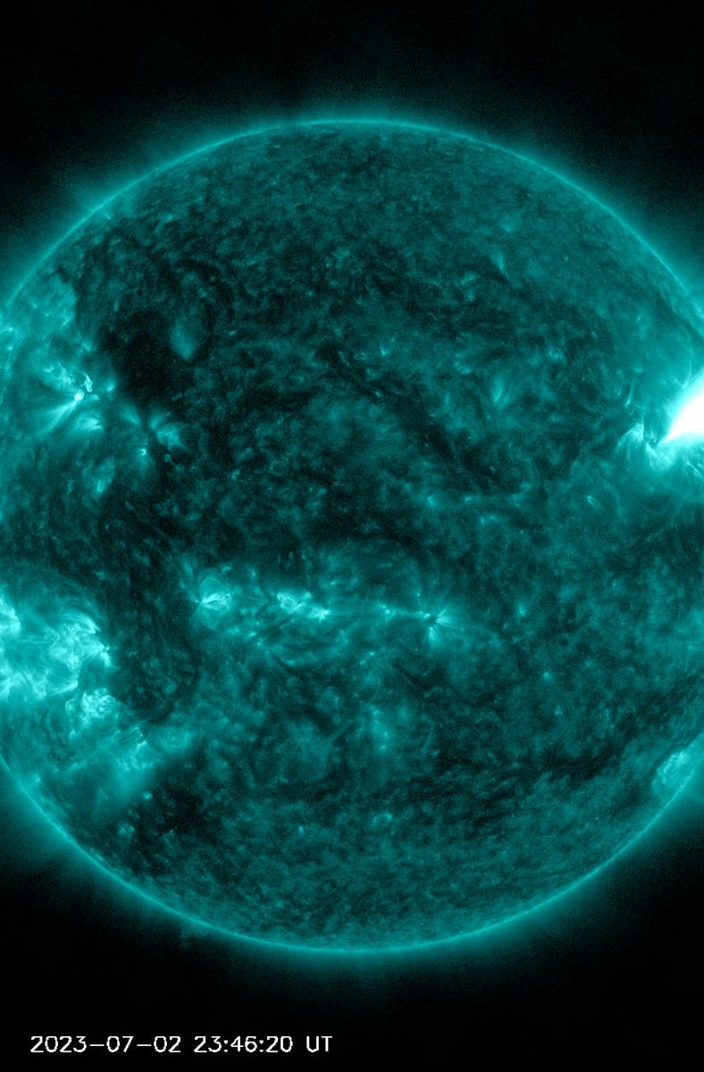A solar flare erupted from the Sun on July 2, 2023. It appears like a vivid absence of color on the ...
