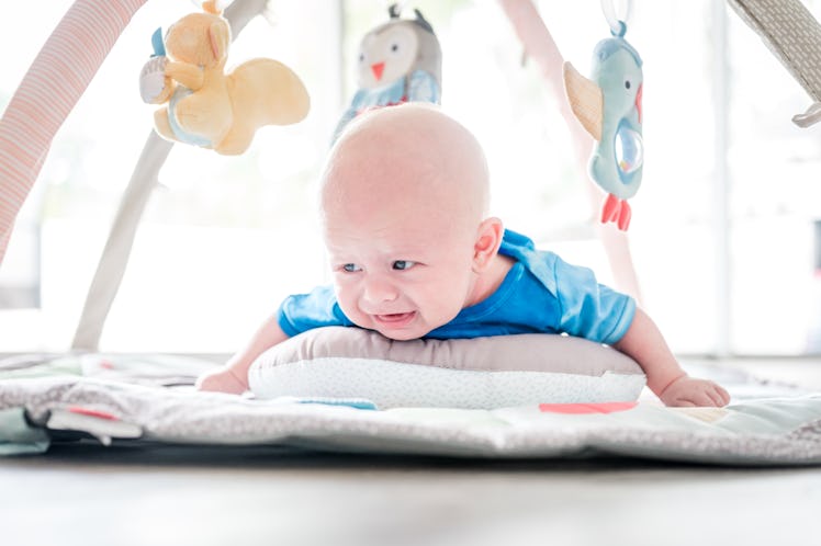 A baby grunting while lying on their tummy.