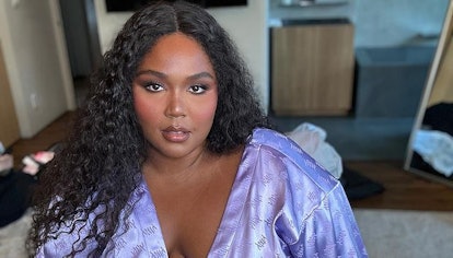 Lizzo long curly hair and purple robe