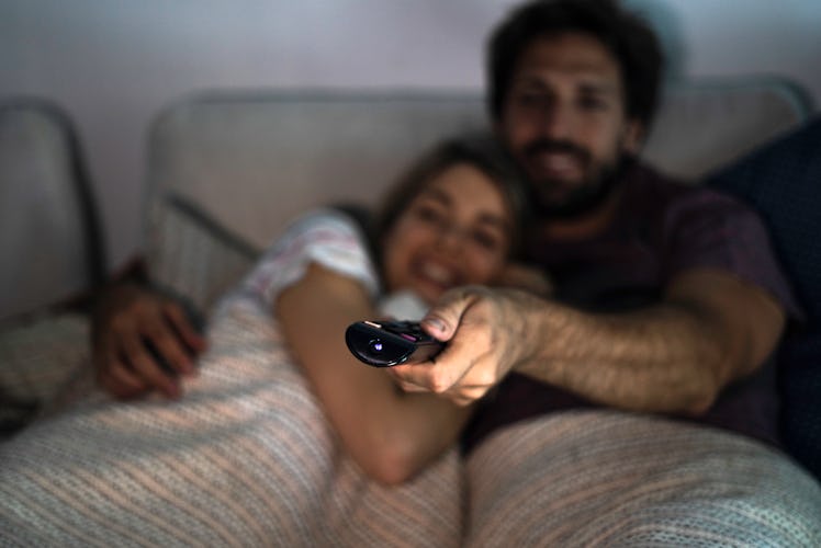 Couple watching TV in bed
