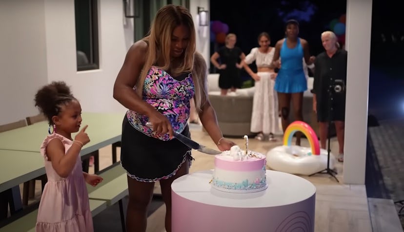 Serena Williams cuts into a cake at her gender reveal party. 