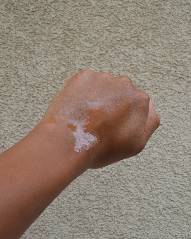 An image of a hand with the e.l.f. Cosmetics Suntouchable! All Set for Sun SPF 45 Spray on it.