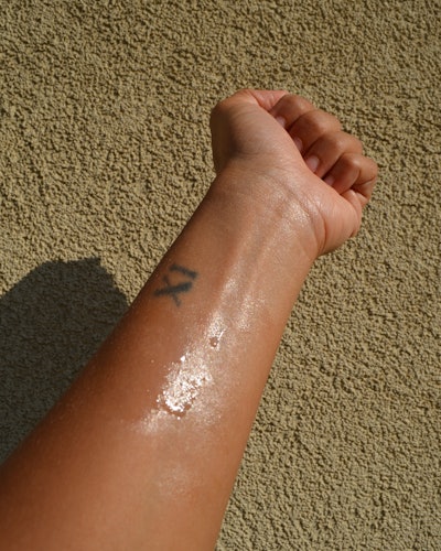 A look at a hand wearing the Supergoop! (Re)setting Refreshing Mist SPF 40.