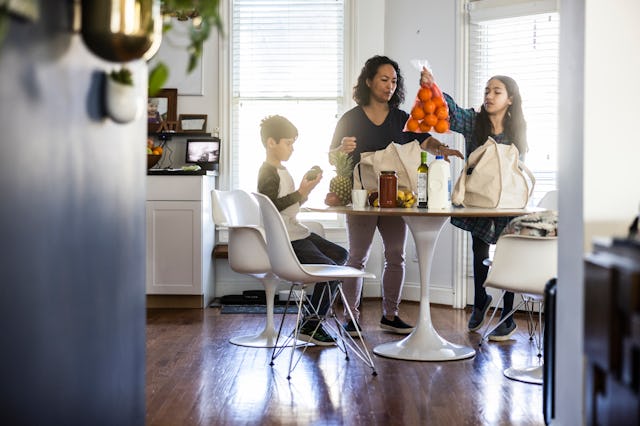 A family unpacks their grocery bags.