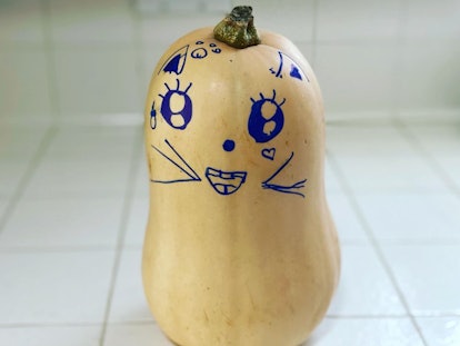 the author's daughter's creation: a squash with an adorable face drawn in blue Sharpie