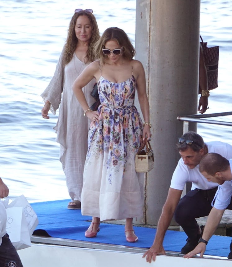 Jennifer Lopez wears a white floral maxi dress and flats while in the Amalfi Coast, Italy.