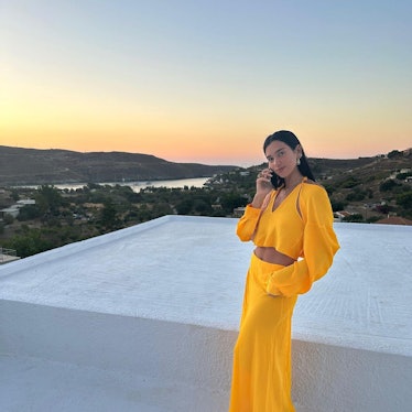 Dua Lipa wears a yellow maxi skirt and cut-out crop top in a photo posted to her Instagram.
