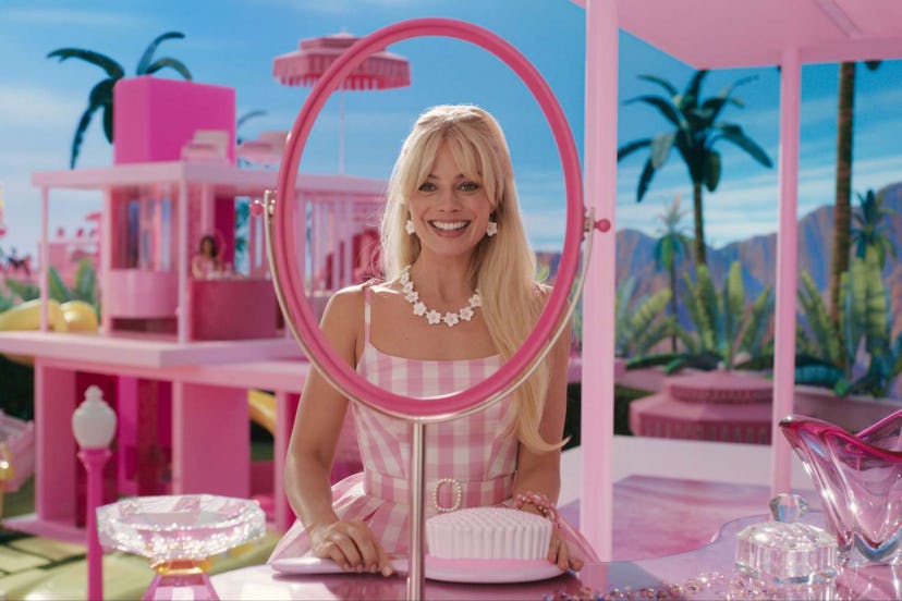 Margot Robbie in Barbie wearing a pink and white checkered dress