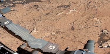 The lower left features a beam and hardware that says "Curiosity" and below it is a barren surface w...