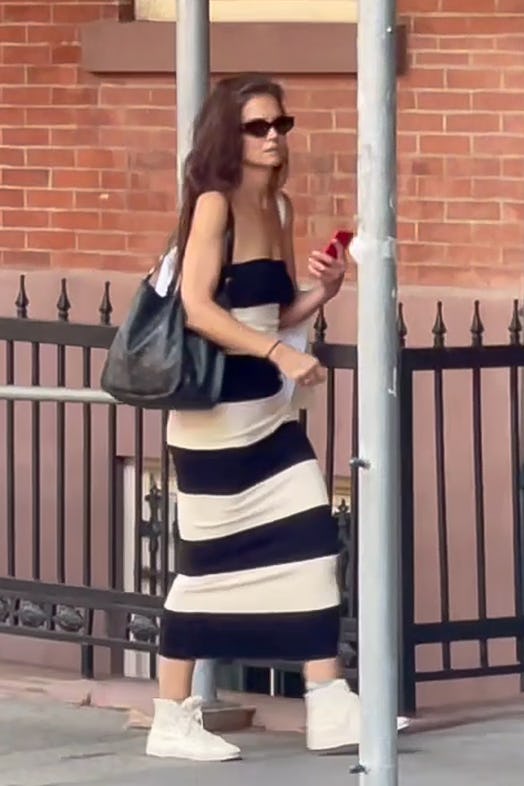Katie Holmes wears a black and white striped strapless dress while out in New York City.