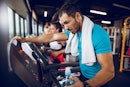一个男人在禁食有氧运动在健身房跑步机上运行,空腹。