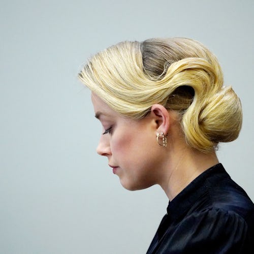 Actress Amber Heard listens in the courtroom at the Fairfax County Circuit Courthouse in Fairfax, Vi…