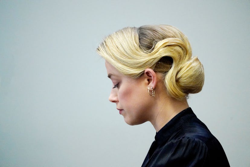 Actress Amber Heard listens in the courtroom at the Fairfax County Circuit Courthouse in Fairfax, Vi...