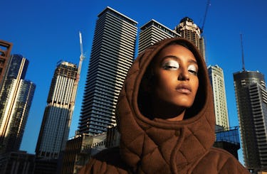 Model Mona Tougaard wears a brown coat.