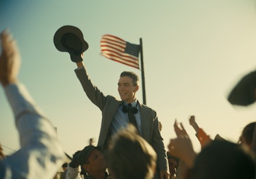 Cillian Murphy's J. Robert Oppenheimer stands near an American flag in 'Oppenheimer'