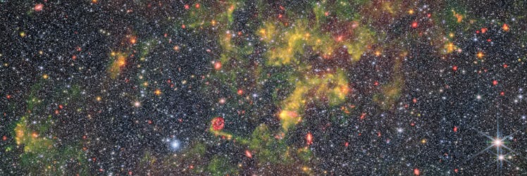 photo of clouds of yellow gas against a dense starfield in space