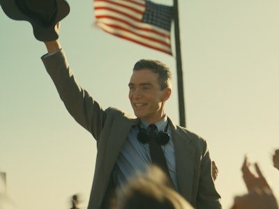 Cillian Murphy stands under an American flag in 'Oppenheimer'