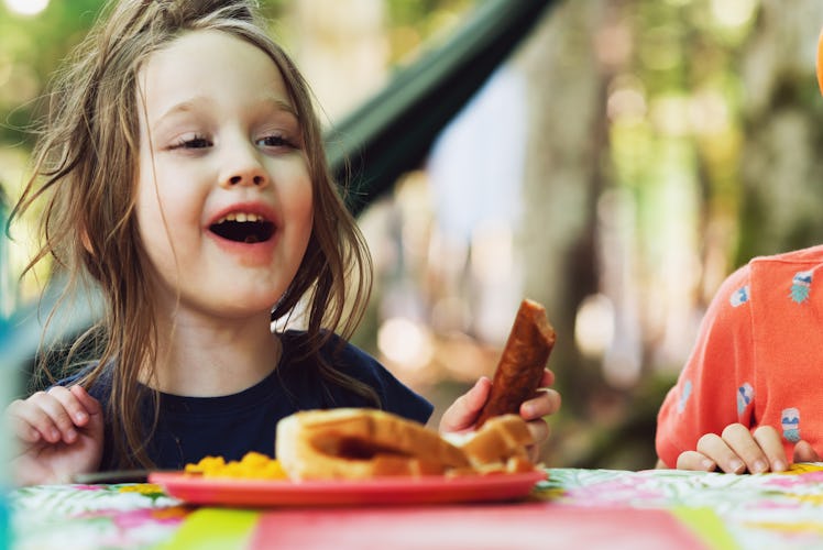 A child eating a hot dog.