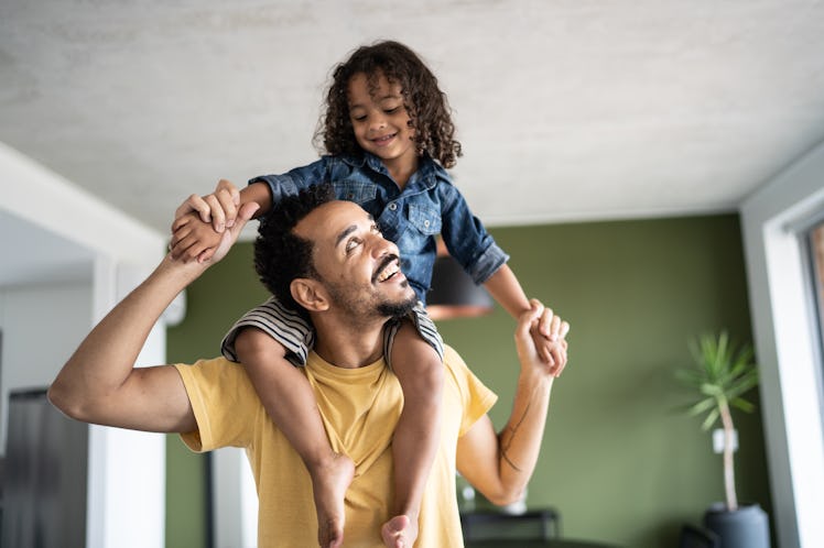 A dad with his autistic child on his shoulders.