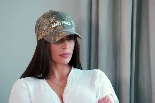 Kim Kardashian wears a camo print cap on Keeping Up With The Kardashians.