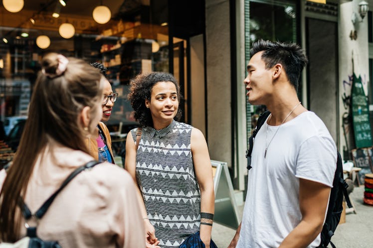 Group of people talking, with one man not reading the room